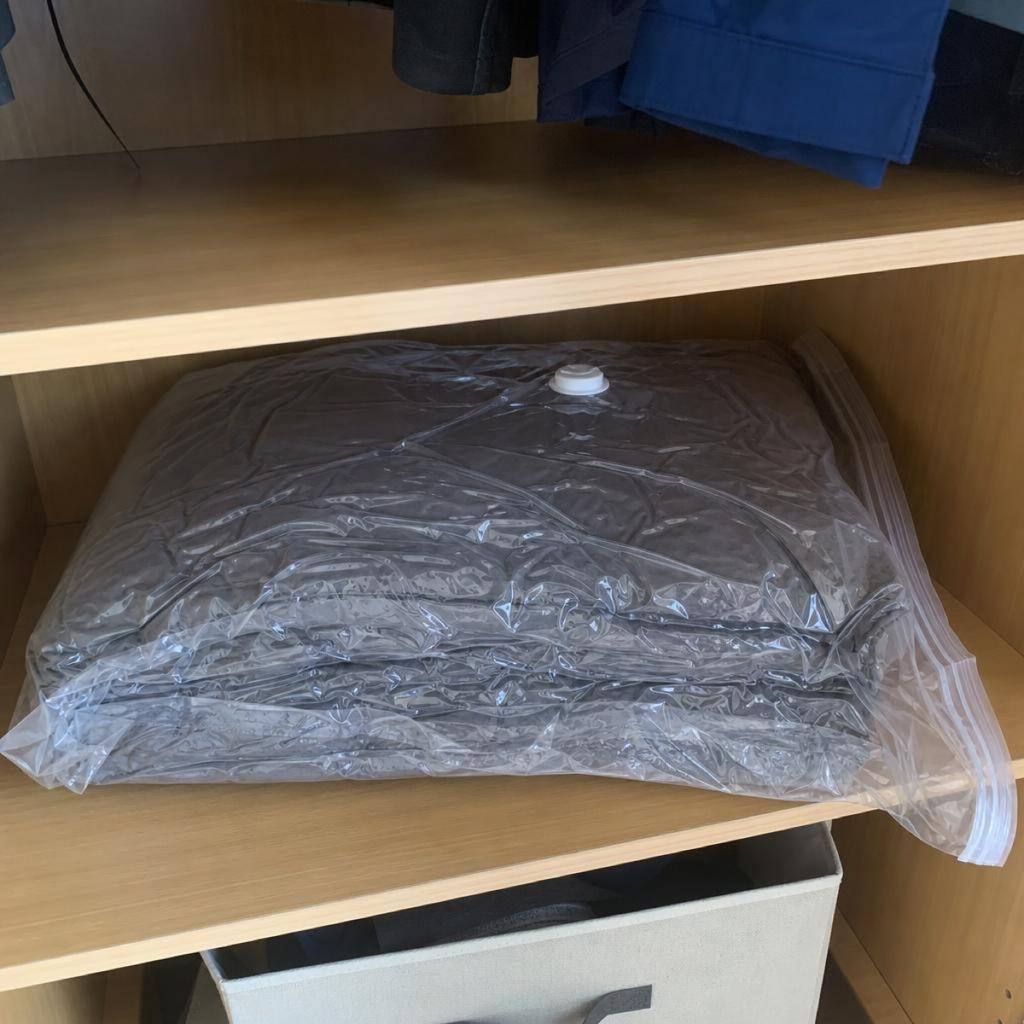 A vacuum-sealed winter blanket on a closet shelf